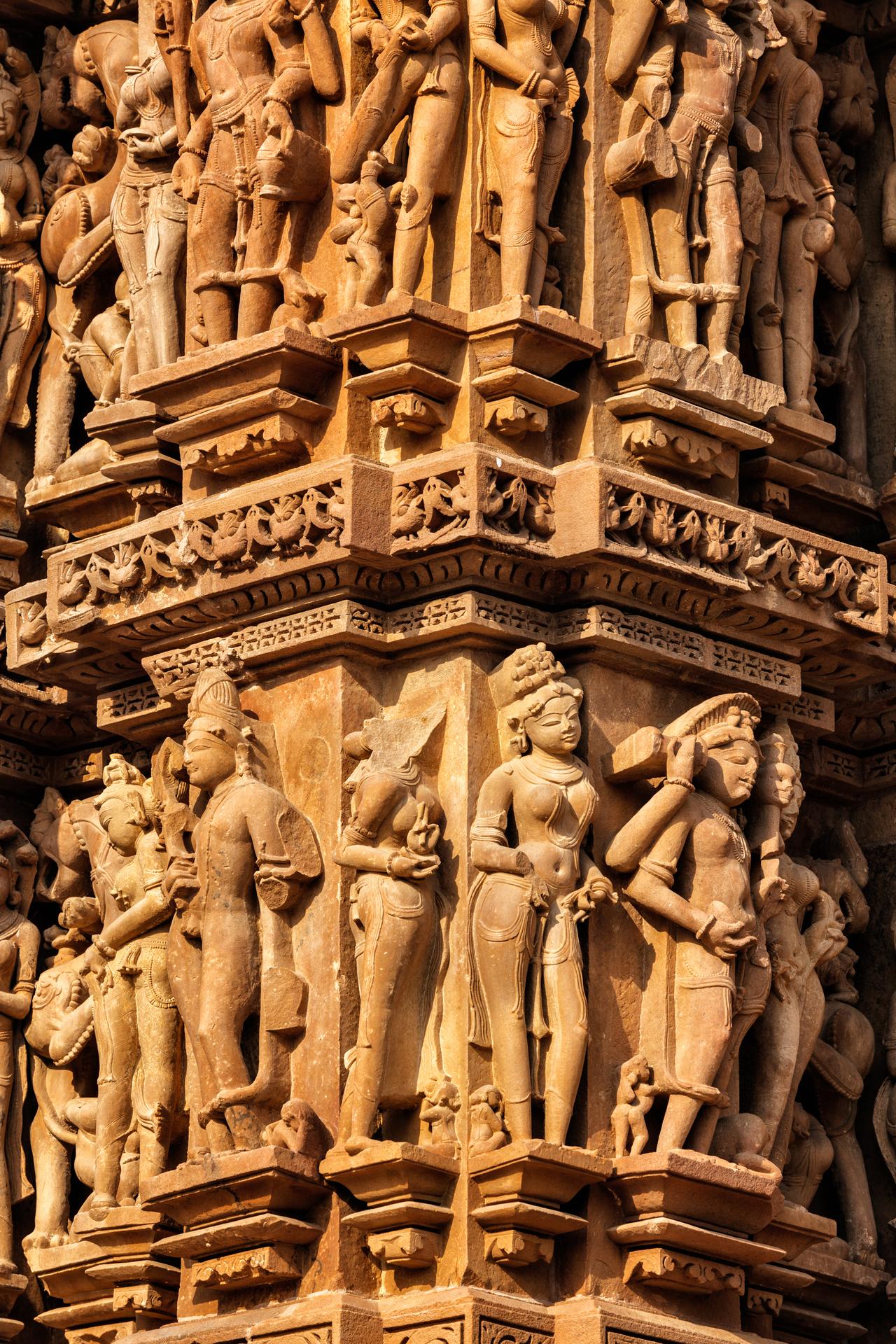 Hand-carved stone figures covering a temple wall.